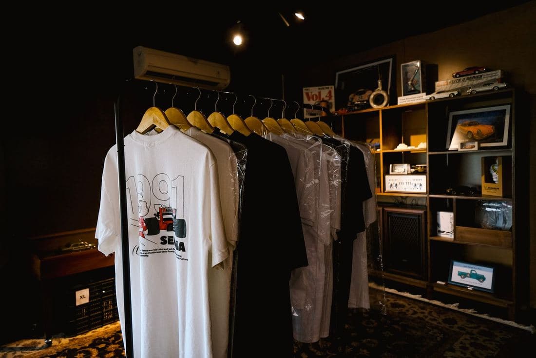 Vintage band and graphic T-shirts hung on a wall